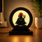 Modern LED table decor lamp featuring a glowing Lord Shiva silhouette design on a wooden base, placed on a table with warm ambient lighting and indoor home decor background.